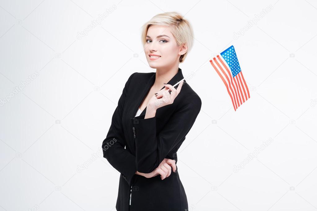 Smiling businesswoman holding USA flag