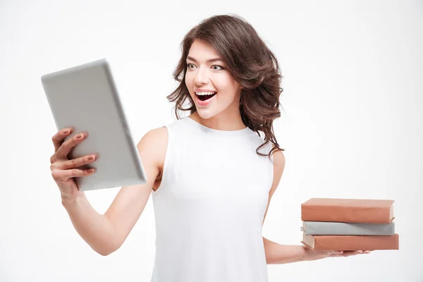 Woman choosing between tablet computer and paper books — Stock Photo, Image