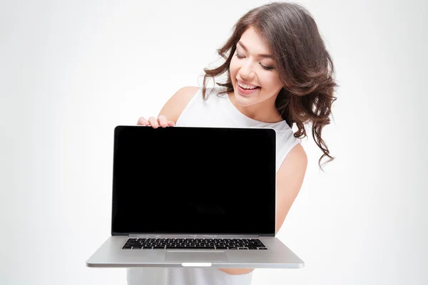 Smiling woman presenting something on blank laptop screen — Stock Photo, Image