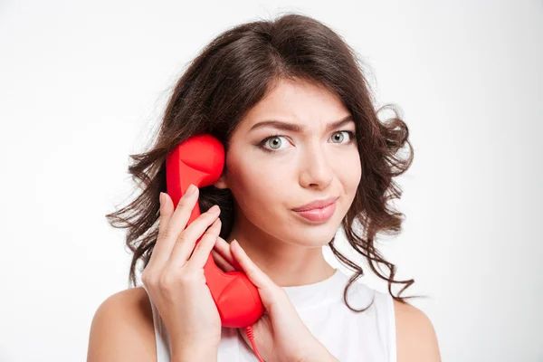 Woman covering microphone on phone tube — Stock Photo, Image