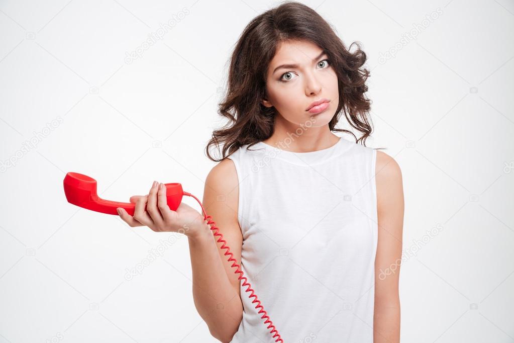 Sad woman holding phone tube
