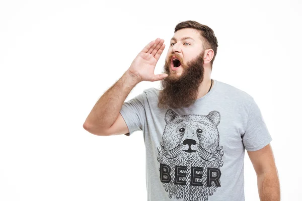 Szép szakállas férfi hangosan kiabálva, kéz, száj közelében — Stock Fotó