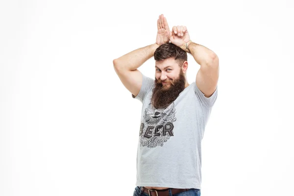 Playful funny bearded man making bunny ears by hands — Stock Photo, Image