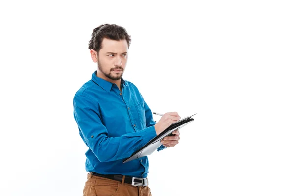 Businessman writing notes in clipboard — Stock Photo, Image