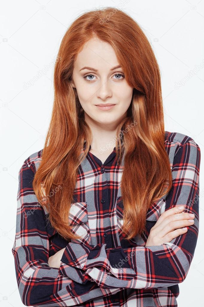 Happy redhead woman with arms folded