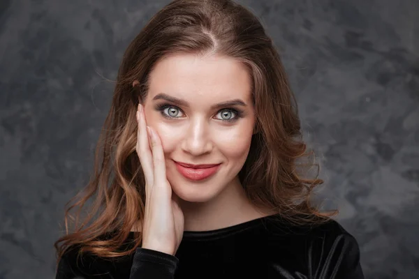 Smiling attractive young woman touching her cheek — Stock Photo, Image