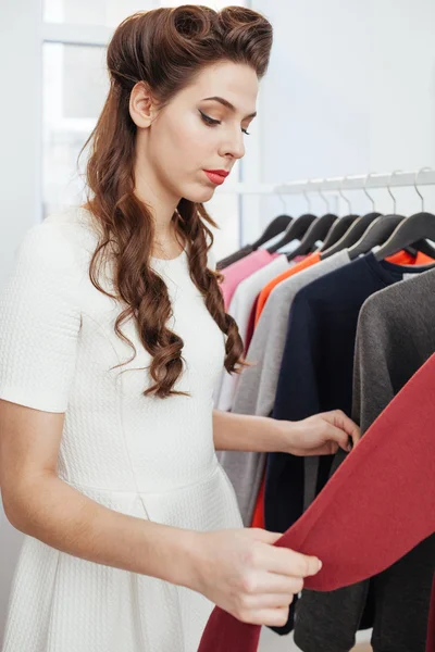 Mujer eligiendo vestido en la tienda —  Fotos de Stock