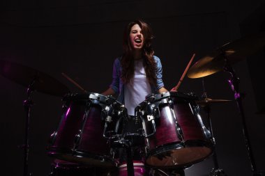 Woman playing the drums clipart