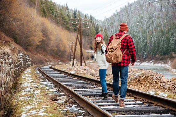 Beautiful couple walking on railroad together — Stock Photo, Image