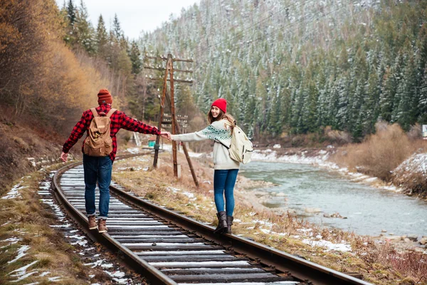 Couple walking on old railroad in mountains — Stock Photo, Image