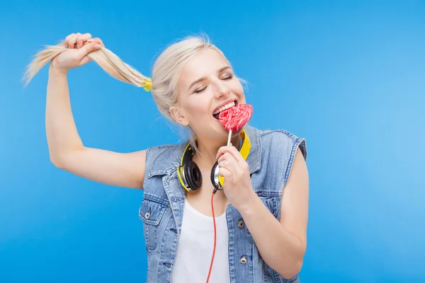 Stylish female teenager eating lollipop — Stock Photo, Image