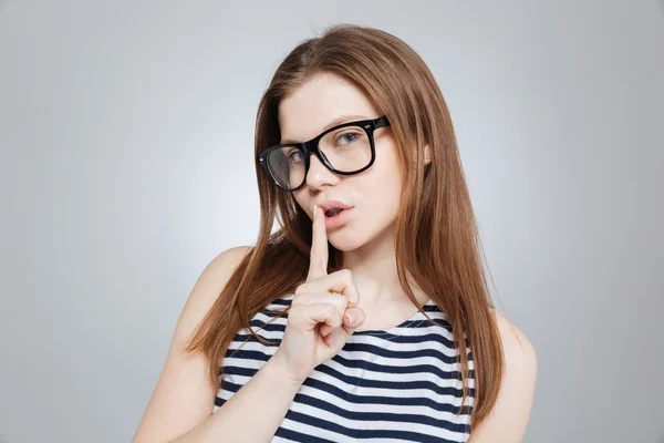 Привлекательная девушка-подросток в очках показывает жест молчания — стоковое фото