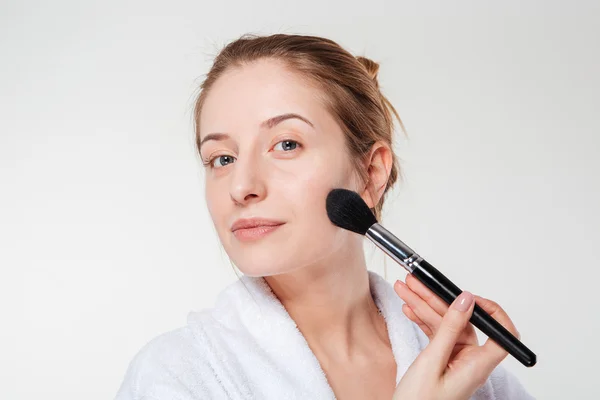 Young woman with cosmetic brush — Stock Photo, Image