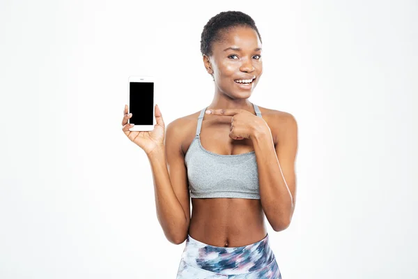 Cheerful pretty young african american sportswoman holding blank screen smartphone — Stock Fotó