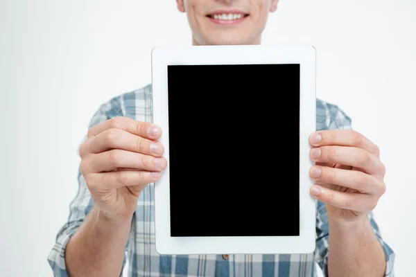 Blank screen tablet holded by cheerful attractive young man — Stock Photo, Image