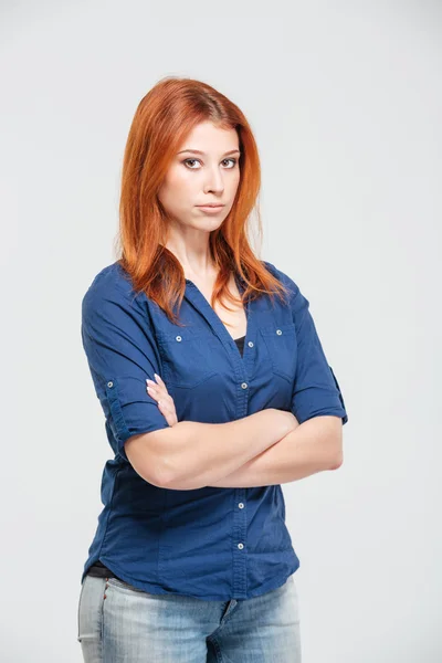 Beautiful redhead young woman standing with arms crossed — Stock fotografie