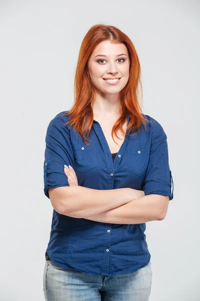 Happy attractive redhead young woman standing with arms crossed — Stockfoto