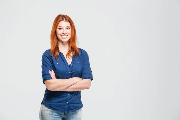 Cheerful pretty redhead young woman standing with hands folded — Zdjęcie stockowe