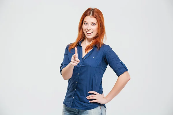 Cheerful attractive redhead young woman pointing on you — Stock fotografie