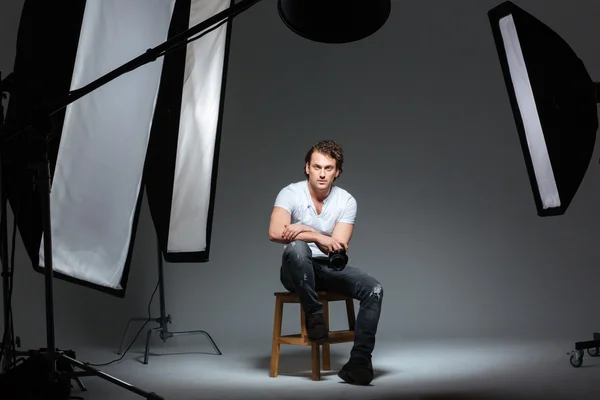 Male photograph sitting on the chair — Stock Photo, Image