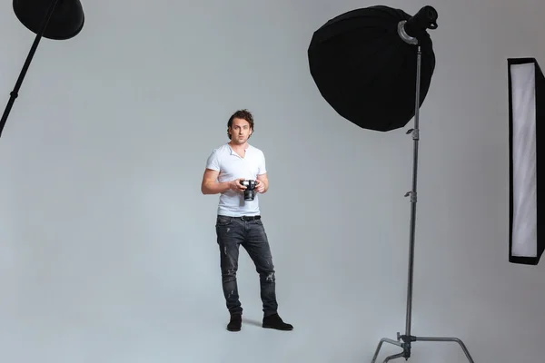 Photographer standing in professional studio — Stock Photo, Image