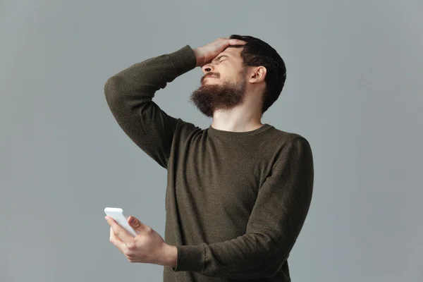 Stressed man holding smartphone — Stock Photo, Image