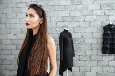 Tuğla duvar ile duran kadın 