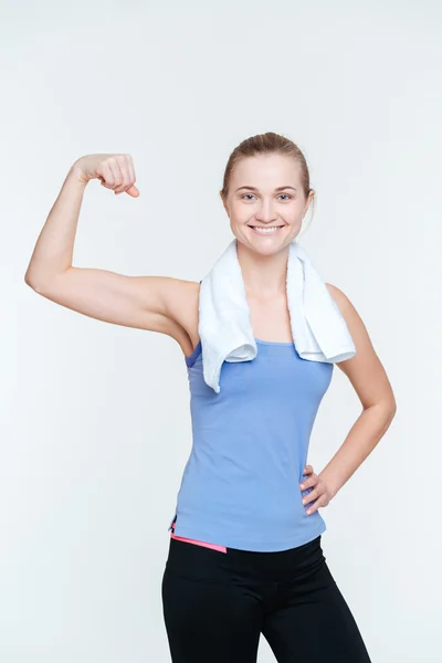 Happy fit woman showing her biceps — Stock Photo, Image