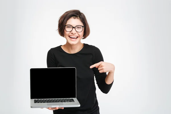 Woman pointing finger on blank laptop computer screen — Stock Photo, Image