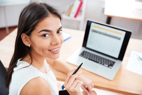 Businesswoman sitting at her workplace in office — Stock Photo, Image