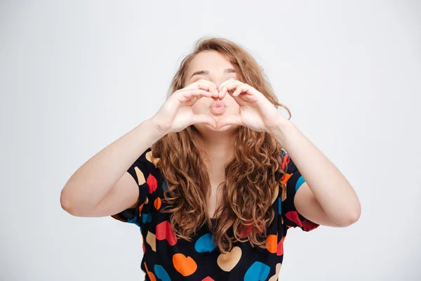 Woman showing heart gesture with fingers — Stock Photo, Image