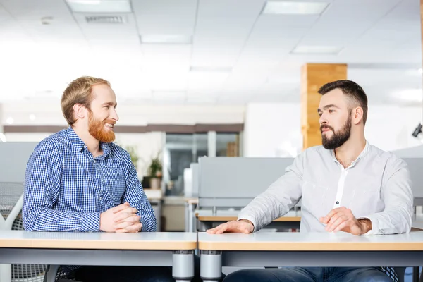 Dvě veselé podnikatelé sedí a mluví v úřadu — Stock fotografie