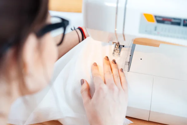 Woman seamstress working and sewing in studio — Stock Photo, Image