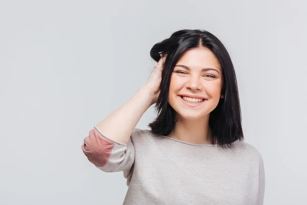 Woman touching her hair over white background — Stock Photo, Image