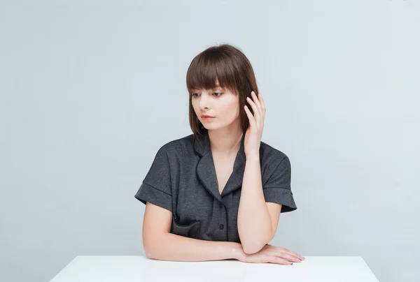 Thoughtful woman sitting at the table — Stock Photo, Image