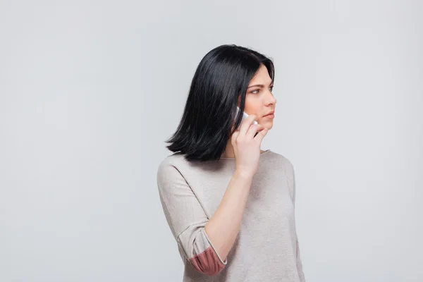 Serious brunette girl making a phone call — Stock Photo, Image