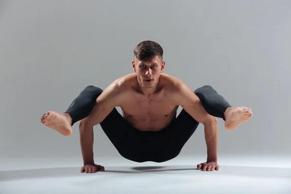 Handsome man doing yoga exercises — Stock Photo, Image