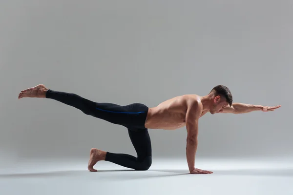 Bonito homem fazendo exercícios de alongamento — Fotografia de Stock