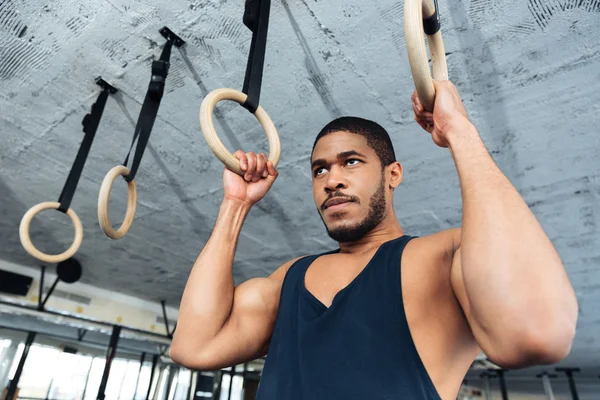 Fitness man doing dipping exercise using rings — Stock Photo, Image