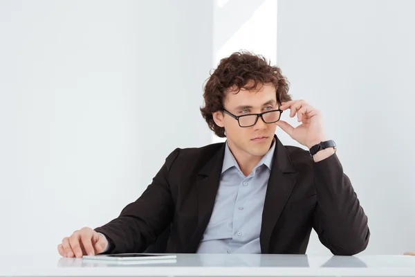 Seriöser Geschäftsmann sitzt an seinem Arbeitsplatz — Stockfoto