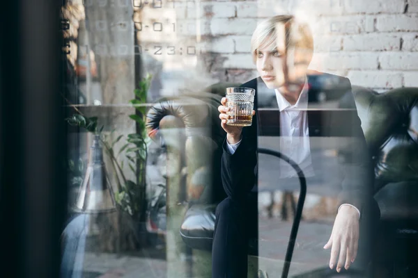 Elegante chica rubia bonita sosteniendo un vaso de alcohol — Foto de Stock