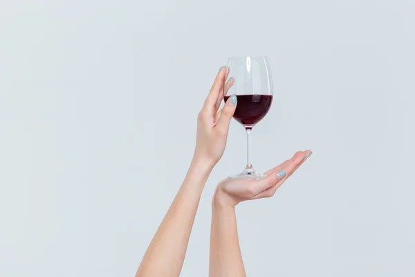 Female hands holding glass with wine — Stock Photo, Image