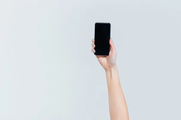 Female hand holding smartphone with blank screen — Stock Photo, Image