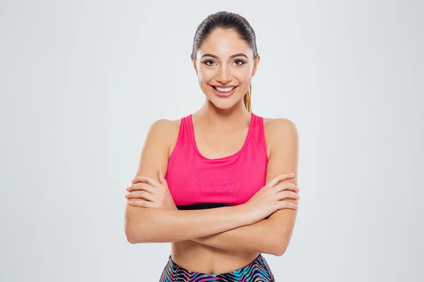 Smiling sports woman standing with arms folded — Stock Photo, Image