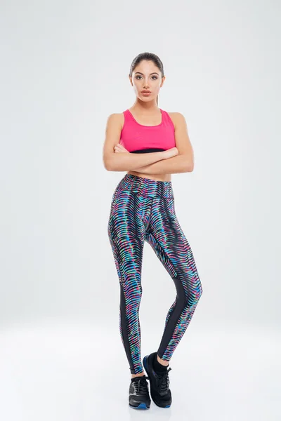 Serious fitness woman standing with arms folded — Stock Photo, Image