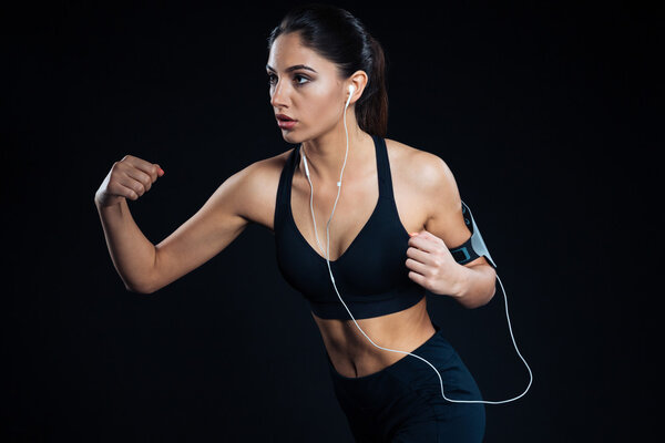 Portrait of a fitness woman training with earphones