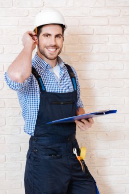 Onun panoya notlar alarak gülümseyen genç işçi