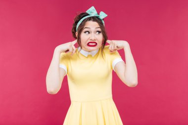 Sevimli tahriş pinup kız kulakları parmak tarafından kapalı.