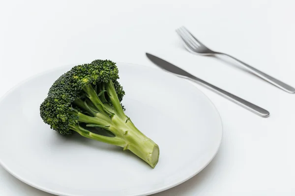 Fork, knife and broccoli on the plate — Stock Photo, Image