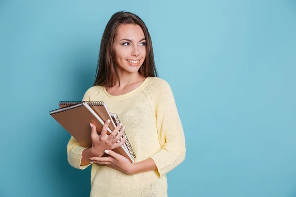 Portrait of beautiful young brunette with notebooks — Stock Photo, Image